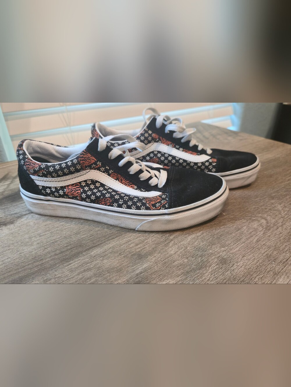 These are Vans Old Skool sneakers in the "Tiger Floral" print.